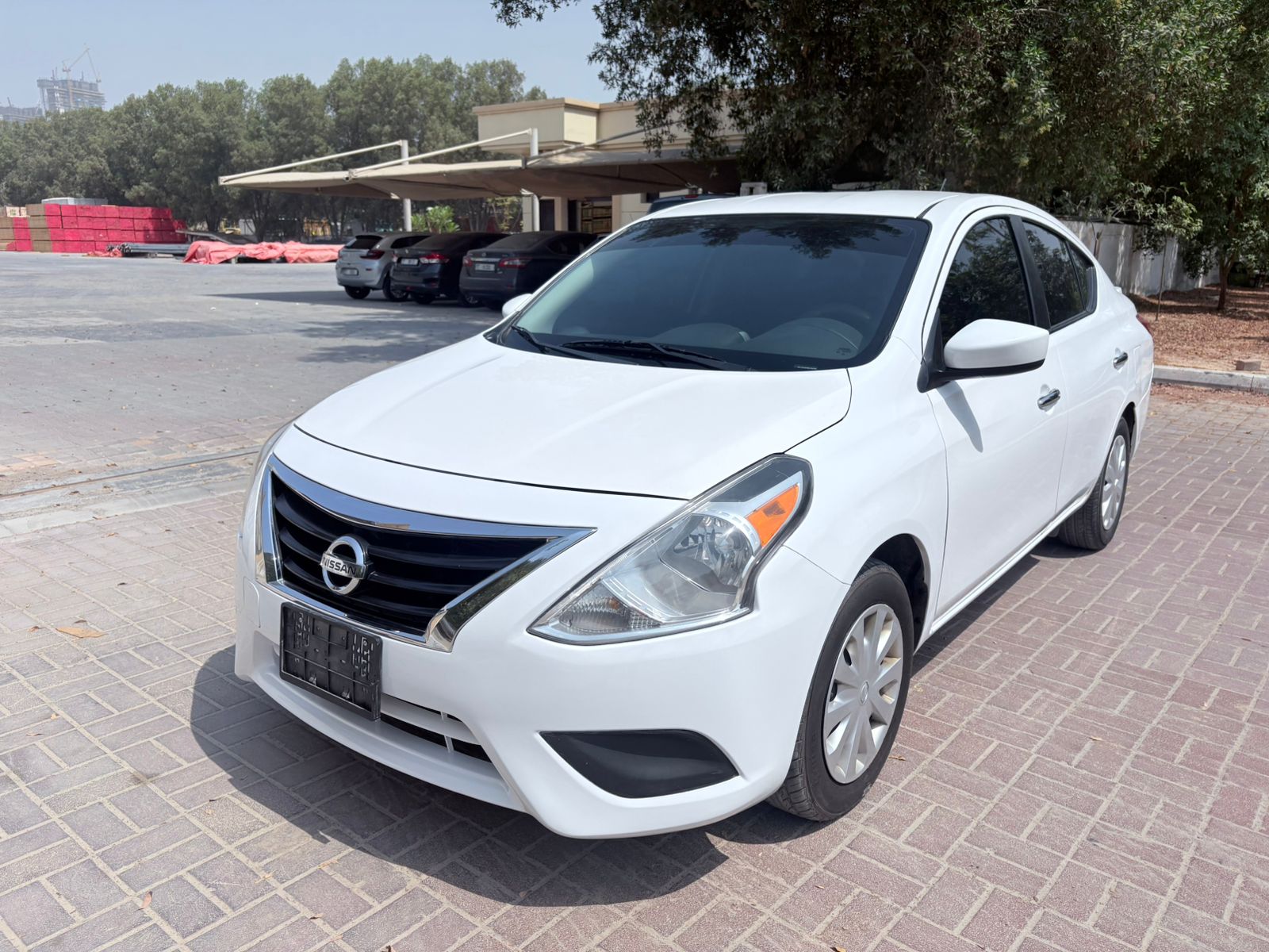 A clear front-side view of the Nissan Versa 2017 model, showcasing its design and body style, commonly seen on roads in the UAE